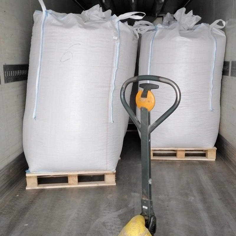 Industrial wood pellets 1 tonne bulk bags stacked in warehouse