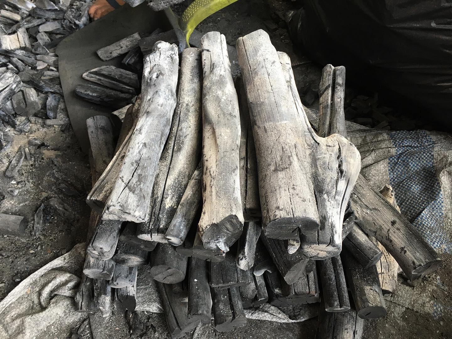 Hardwood charcoal logs stacked, ready for wholesale packaging